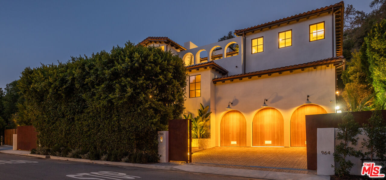 966 Stone Canyon Road Los Angeles, CA 90077 - Photo 23 of 30 a view of a house with a yard