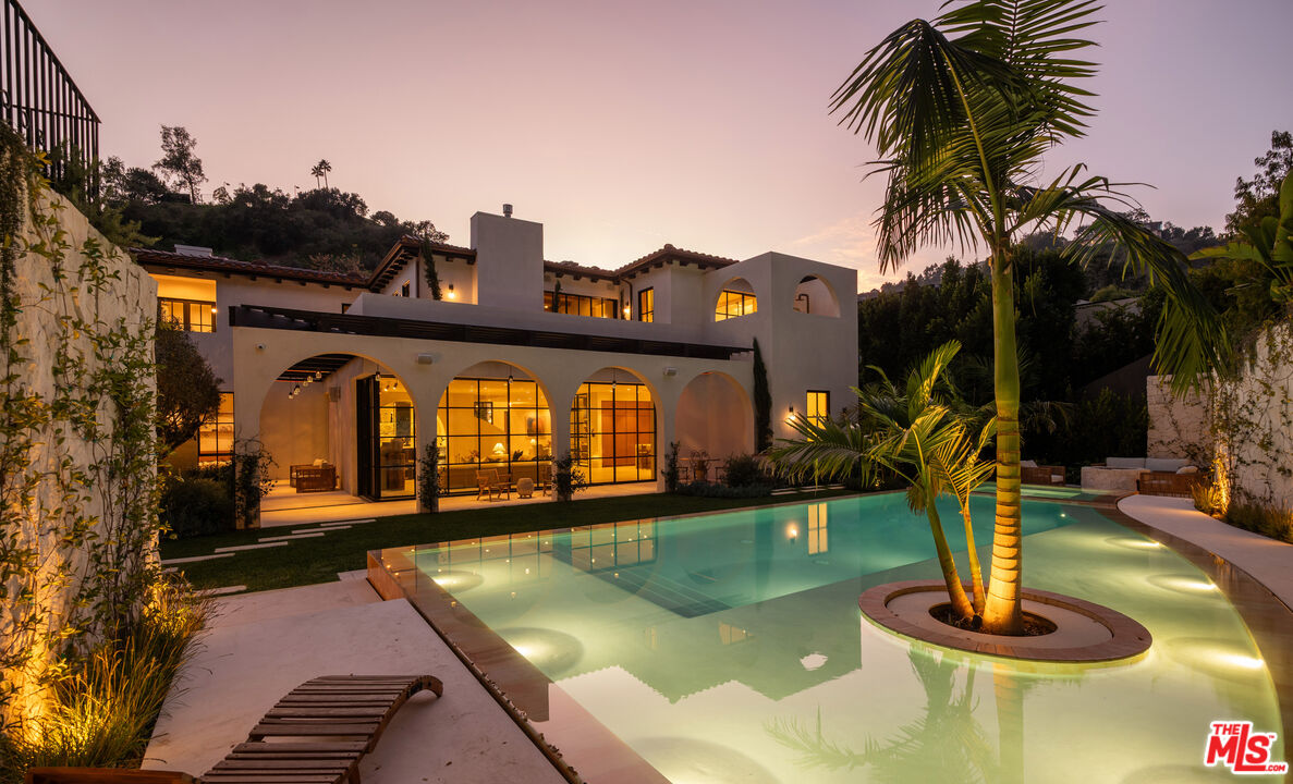 966 Stone Canyon Road Los Angeles, CA 90077 - Photo 26 of 30 a view of a swimming pool with a yard