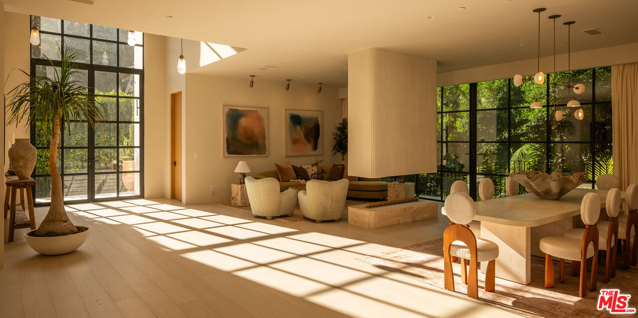 966 Stone Canyon Road Los Angeles, CA 90077 - Photo 3 of 30 a bedroom with a balcony a bed and a chandelier