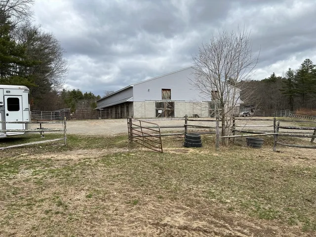 a view of a yard with wooden fence