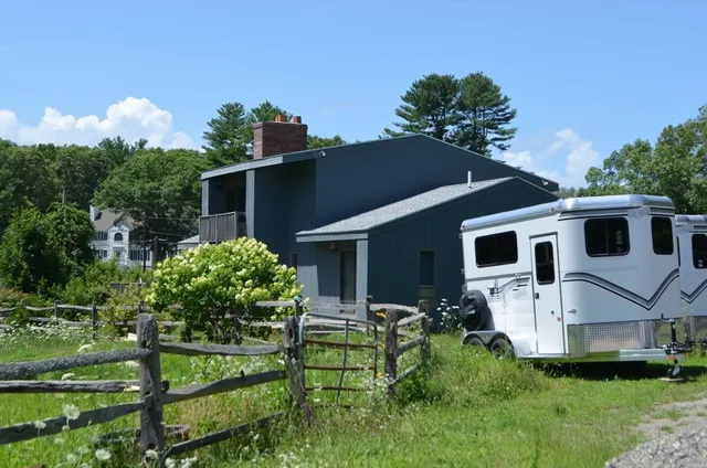 a front view of house with yard and green space