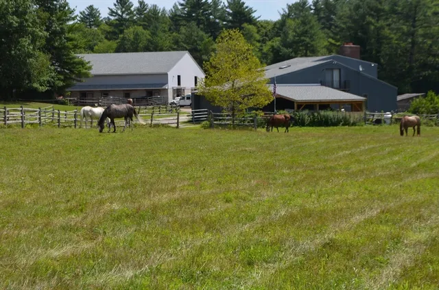 a view of a house with a yard and sitting area
