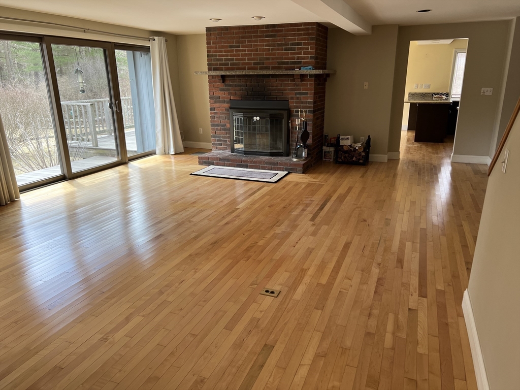 37 East Street Topsfield, MA 01983 - Photo 23 of 39 a view of an empty room with wooden floor and a fireplace
