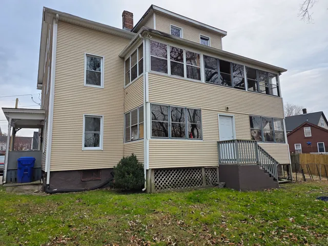 a view of house with a yard