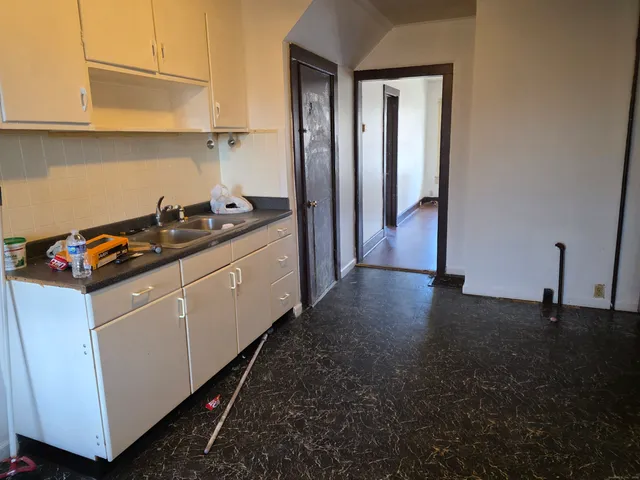 a kitchen with sink cabinets and stove