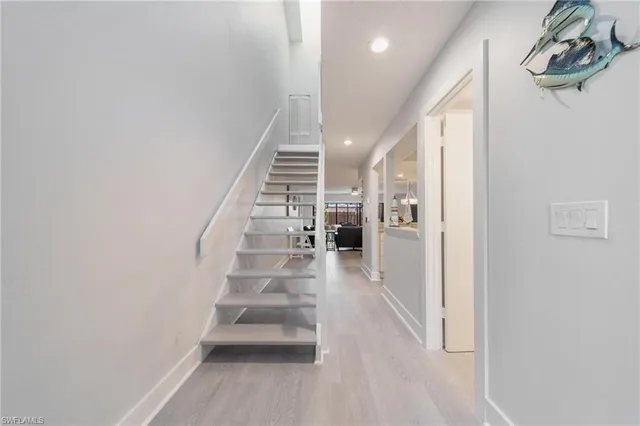 a view of entryway and hall with wooden floor