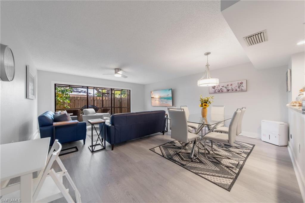 820 Meadowland Drive, Unit D Naples, FL 34108 - Photo 18 of 30 a living room with furniture and a wooden floor