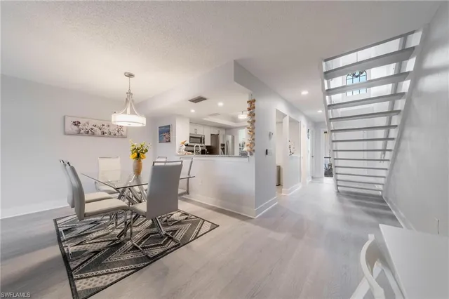 a dining room filled with furniture and a chandelier