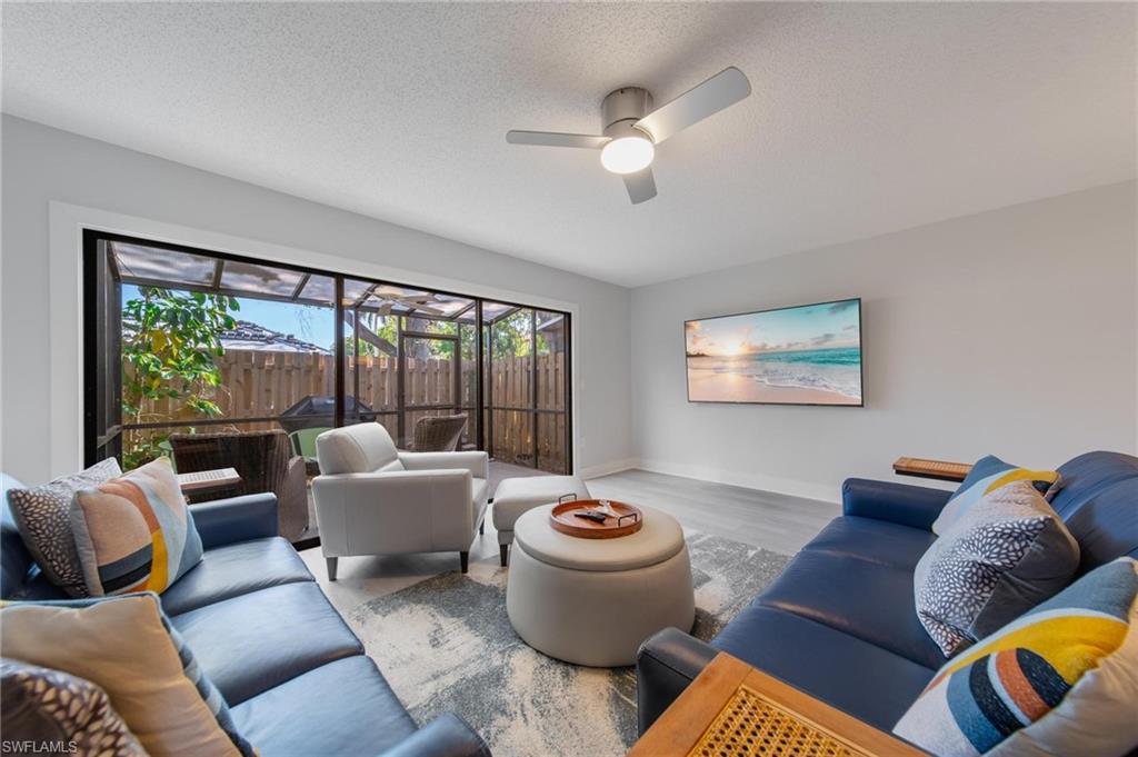 820 Meadowland Drive, Unit D Naples, FL 34108 - Photo 2 of 30 a living room with furniture and a large window