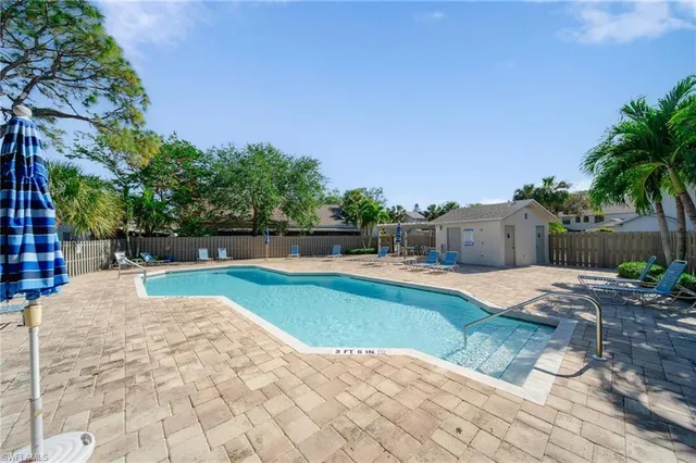 a swimming pool with wooden fence