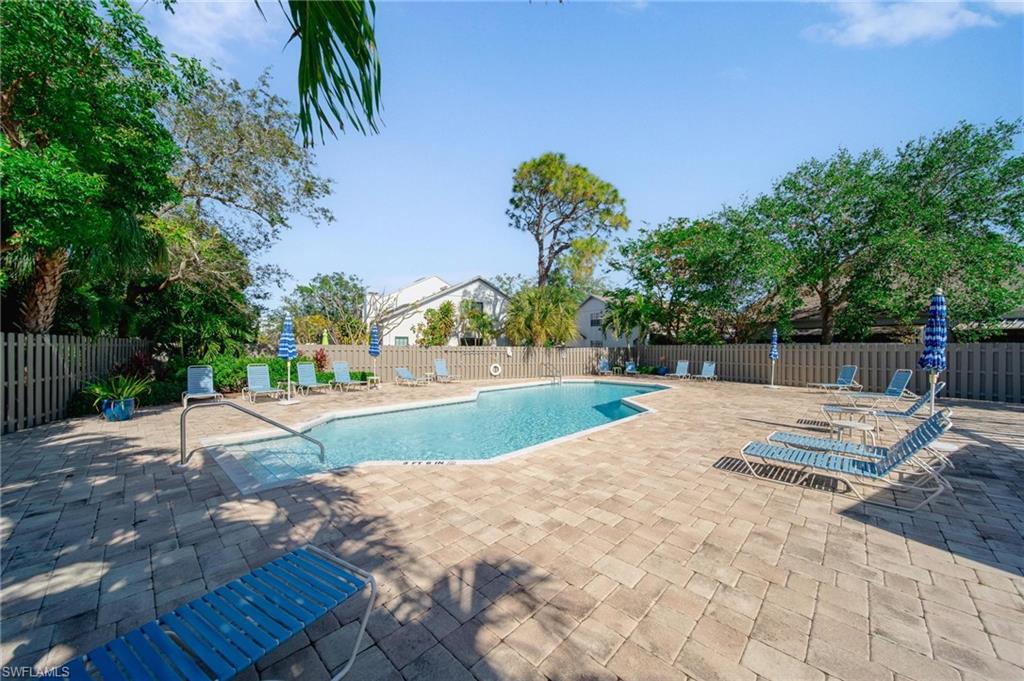 820 Meadowland Drive, Unit D Naples, FL 34108 - Photo 27 of 30 a view of backyard with swimming pool and seating space