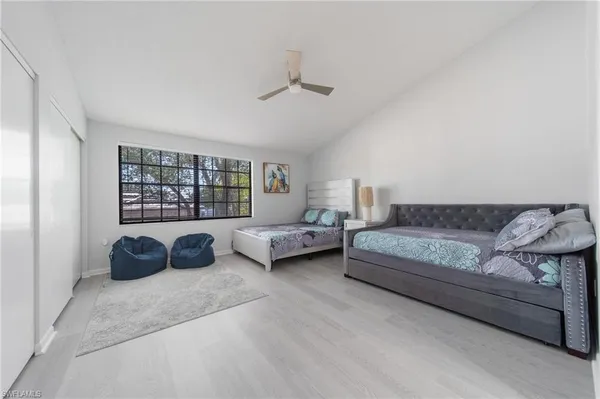 a spacious bedroom with a bed a couch and a window