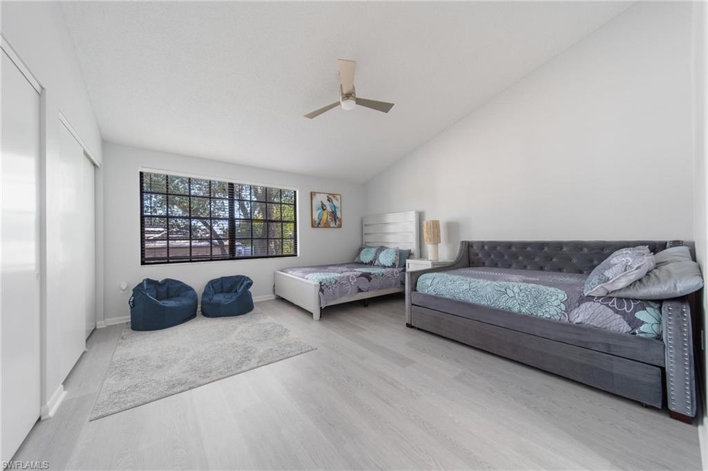 820 Meadowland Drive, Unit D Naples, FL 34108 - Photo 5 of 30 a spacious bedroom with a bed a couch and a window