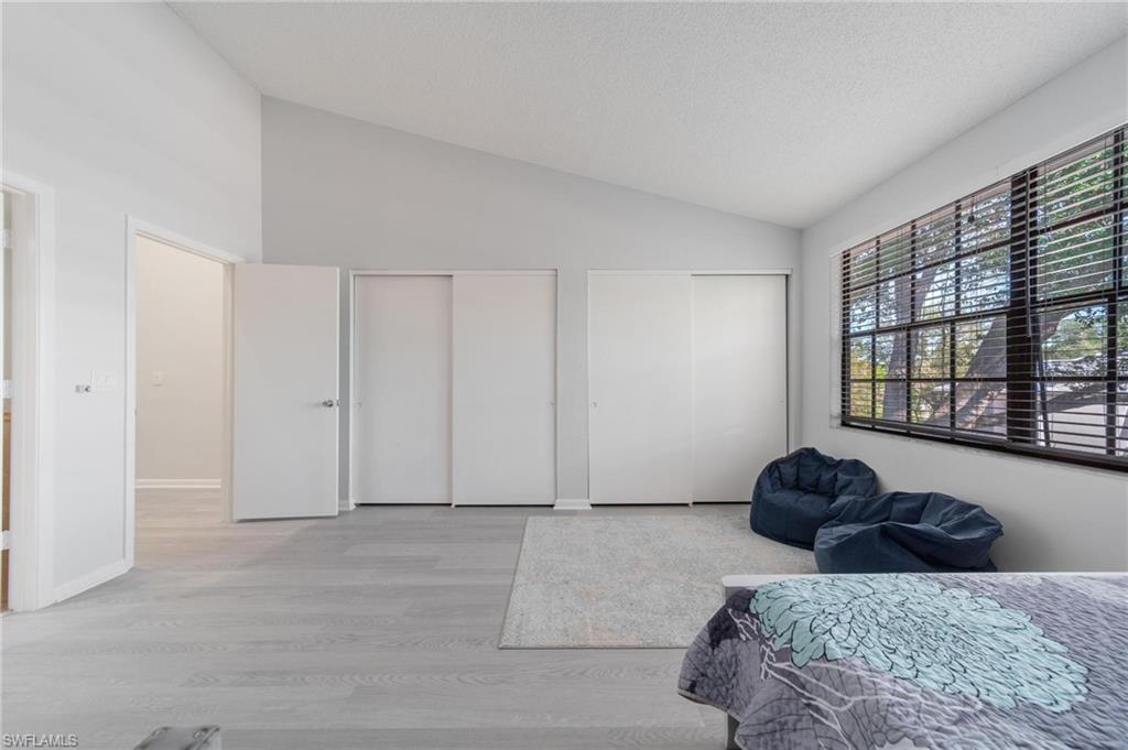 820 Meadowland Drive, Unit D Naples, FL 34108 - Photo 6 of 30 a bedroom with a bed and a window