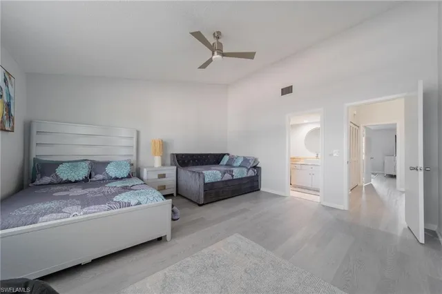 a living room with furniture and a ceiling fan
