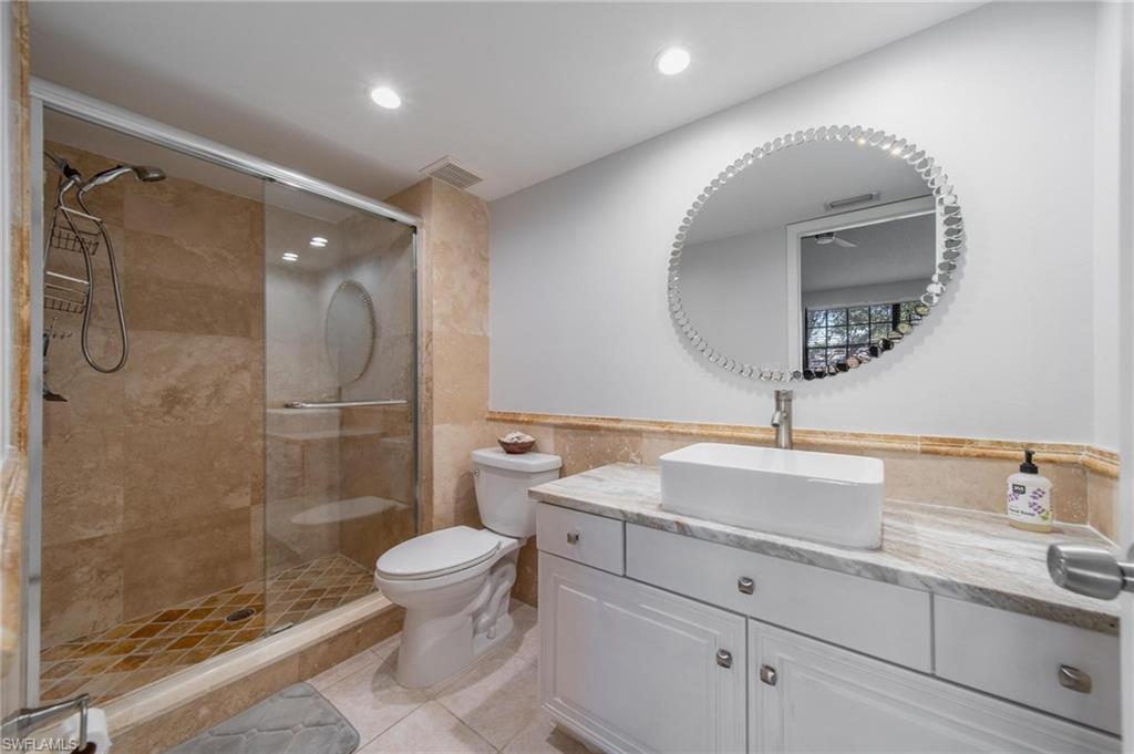 820 Meadowland Drive, Unit D Naples, FL 34108 - Photo 8 of 30 a bathroom with a sink a toilet and shower