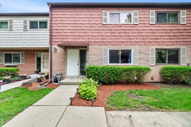 a front view of a house with a yard and outdoor seating