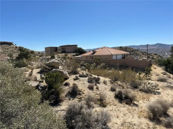 a view of a building with a mountain in the background