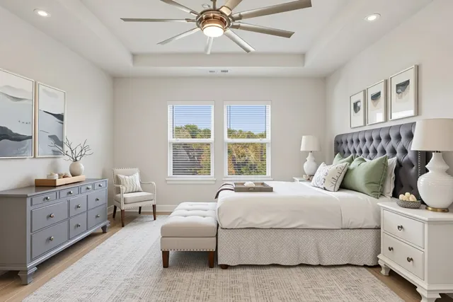 a bedroom with a large bed and a chandelier