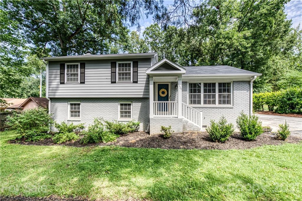 7324 Windyrush Road Charlotte, NC 28226 - Photo 1 of 27 a front view of a house with garden