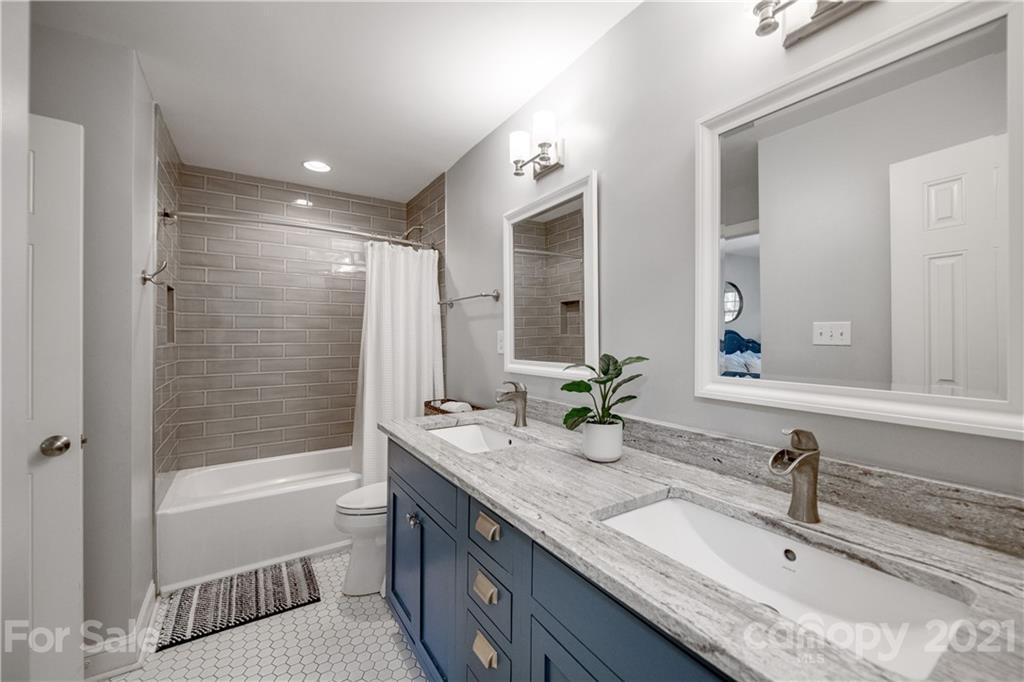 7324 Windyrush Road Charlotte, NC 28226 - Photo 13 of 27 a bathroom with a granite countertop tub sink and mirror