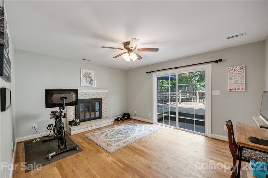 7324 Windyrush Road Charlotte, NC 28226 - Photo 16 of 27 a workspace with furniture and a fireplace