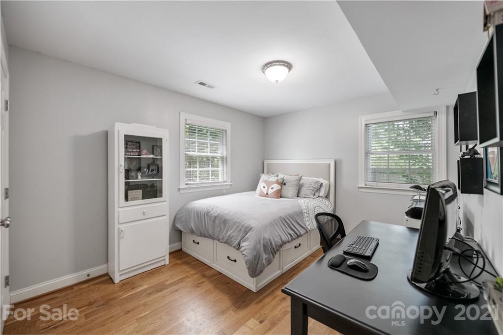 7324 Windyrush Road Charlotte, NC 28226 - Photo 17 of 27 a bedroom with a bed and a flat tv screen