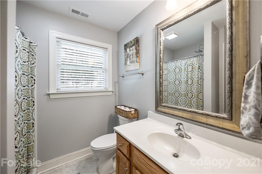 7324 Windyrush Road Charlotte, NC 28226 - Photo 19 of 27 a bathroom with a sink toilet and mirror