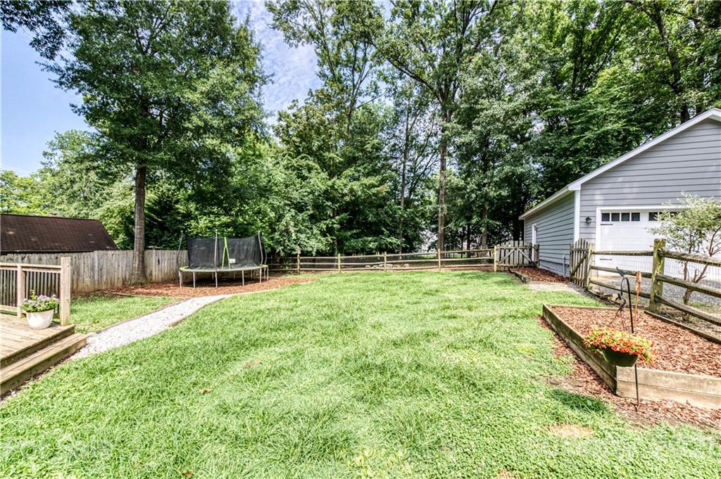 7324 Windyrush Road Charlotte, NC 28226 - Photo 23 of 27 a view of backyard with a garden and swimming pool
