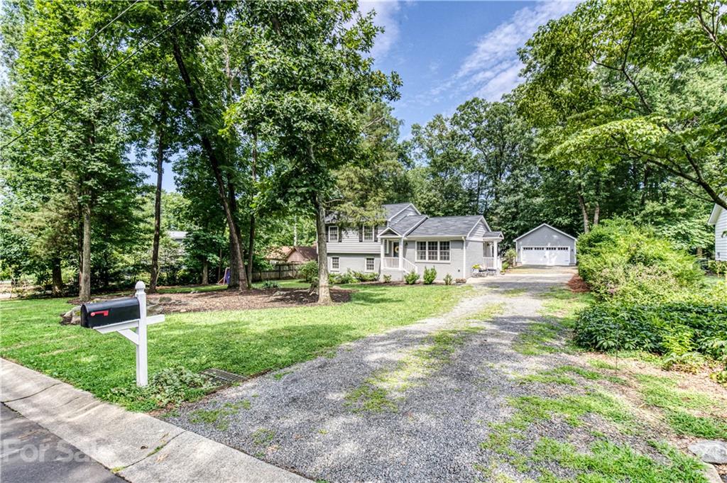 7324 Windyrush Road Charlotte, NC 28226 - Photo 25 of 27 a front view of a house with a yard and trees