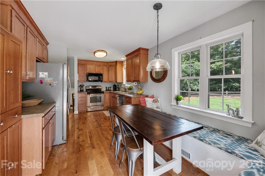 7324 Windyrush Road Charlotte, NC 28226 - Photo 9 of 27 a kitchen with a table chairs and a large window