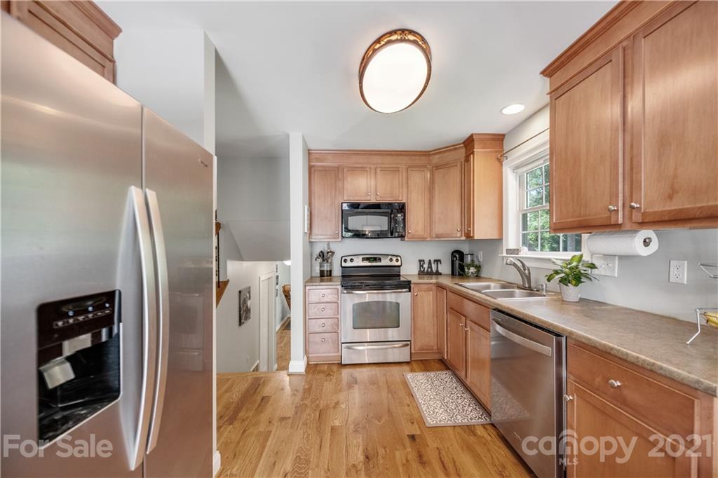 7324 Windyrush Road Charlotte, NC 28226 - Photo 10 of 27 a kitchen with stainless steel appliances granite countertop a refrigerator sink and stove
