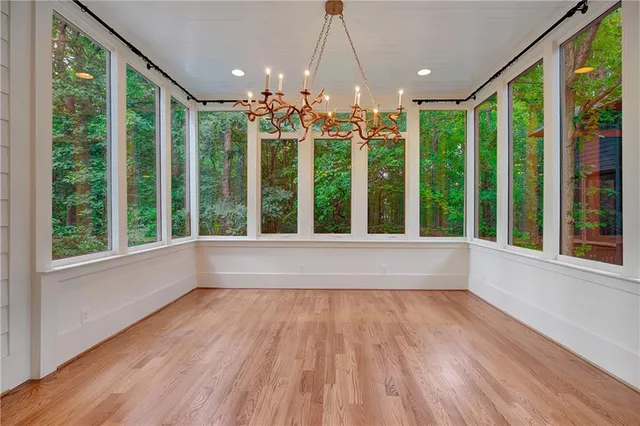a view of an empty room with wooden floor and walls