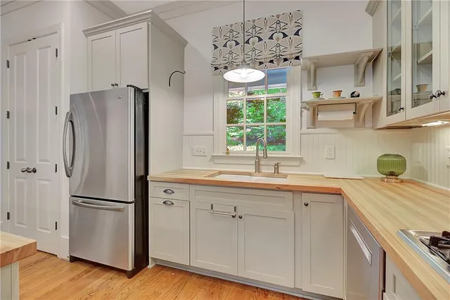 a kitchen with stainless steel appliances a refrigerator and a sink