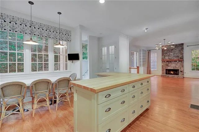 a bathroom with a tub a sink and a large window