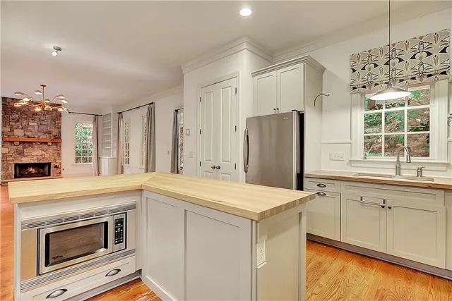 a kitchen with a sink stove and refrigerator