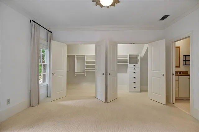 wooden floor and closet area in room