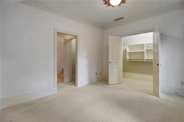 an empty room with a bathroom and a shower