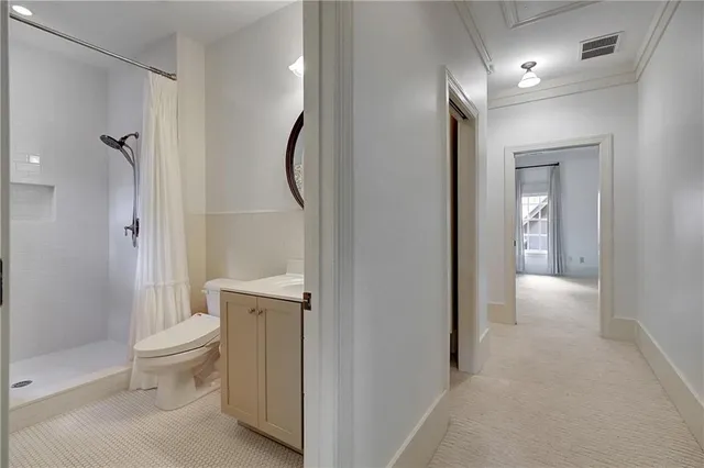 a bathroom with a granite countertop sink a toilet and shower