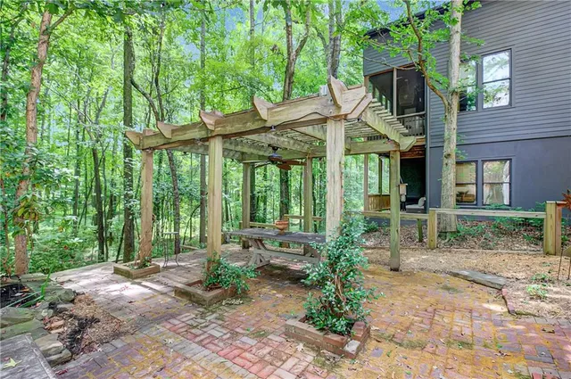 a view of a house with backyard and sitting area