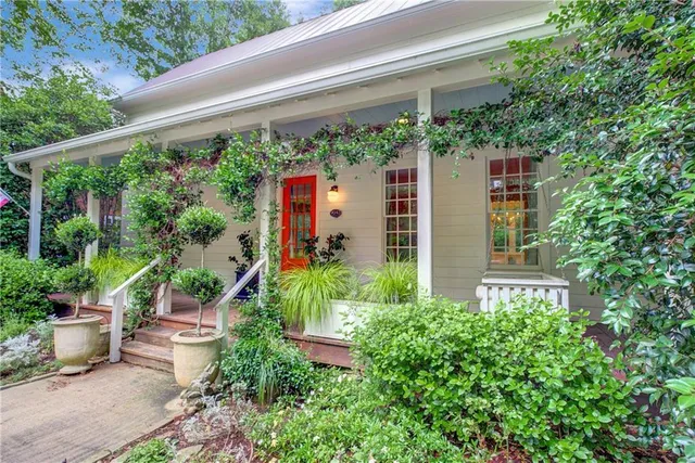 a house with a flower garden in front of it