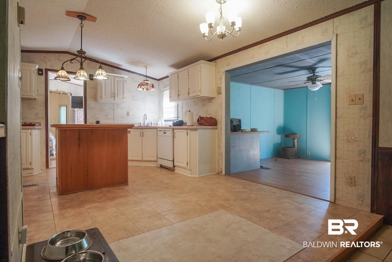 9190 County Road 97 Elberta, AL 36530 - Photo 15 of 53 Kitchen featuring crown molding, light tile patterned floors, ceiling fan with notable chandelier, white dishwasher, and pendant lighting