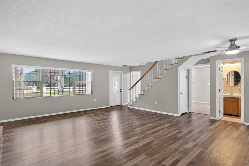 11 Reyes Road DeLand, FL 32724 - Photo 13 of 37 a view of empty room with wooden floor and fan
