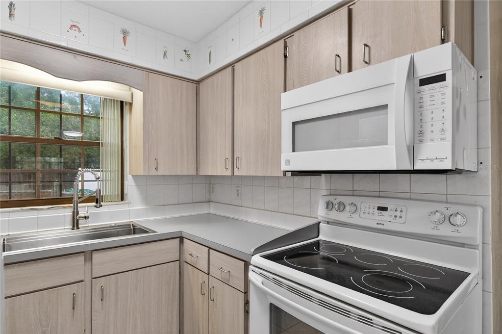 11 Reyes Road DeLand, FL 32724 - Photo 17 of 37 a kitchen with a sink stove and cabinets