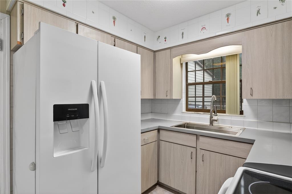 11 Reyes Road DeLand, FL 32724 - Photo 18 of 37 a kitchen with stainless steel appliances a refrigerator and a sink