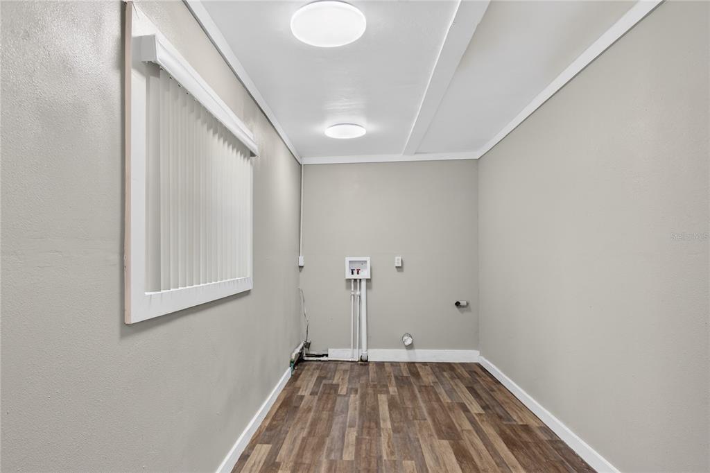 11 Reyes Road DeLand, FL 32724 - Photo 19 of 37 a view of a room with wooden floor and white walls