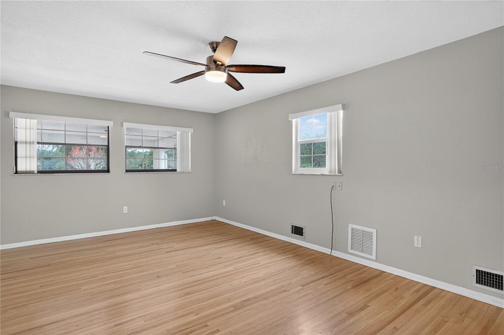 11 Reyes Road DeLand, FL 32724 - Photo 21 of 37 a view of empty room with wooden floor and fan