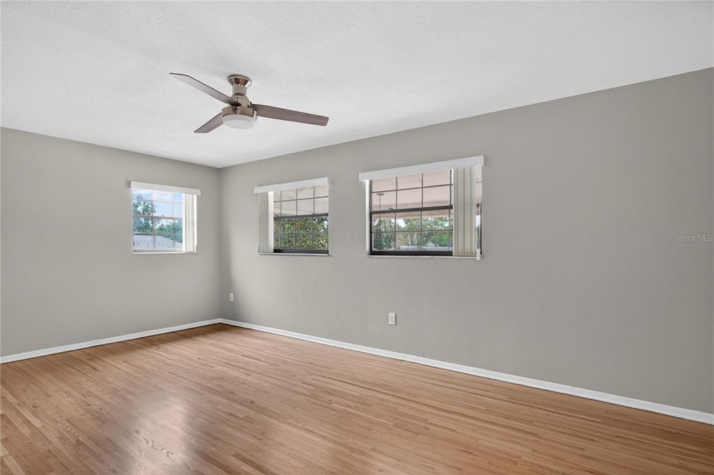 11 Reyes Road DeLand, FL 32724 - Photo 27 of 37 a view of empty room with wooden floor and fan