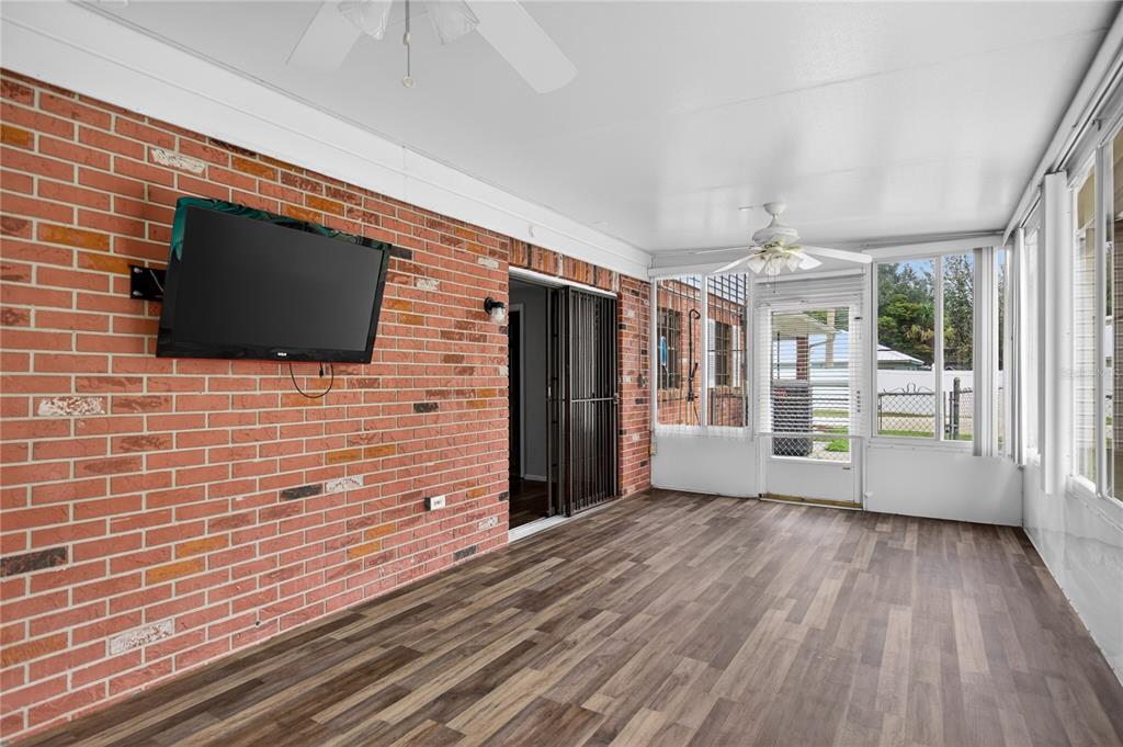 11 Reyes Road DeLand, FL 32724 - Photo 30 of 37 a view of an empty room with wooden floor and a flat screen tv