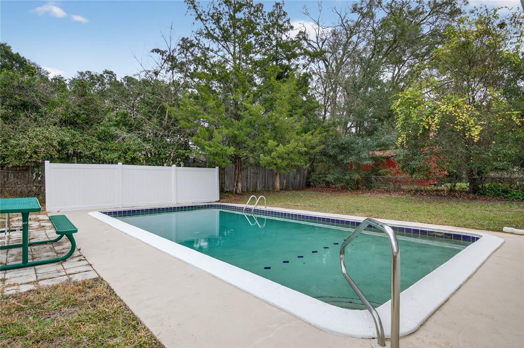 11 Reyes Road DeLand, FL 32724 - Photo 35 of 37 a view of a swimming pool with a bench